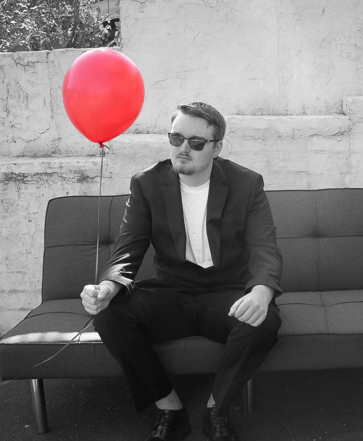 a picture of Ryan Wehr holding a red baloon.